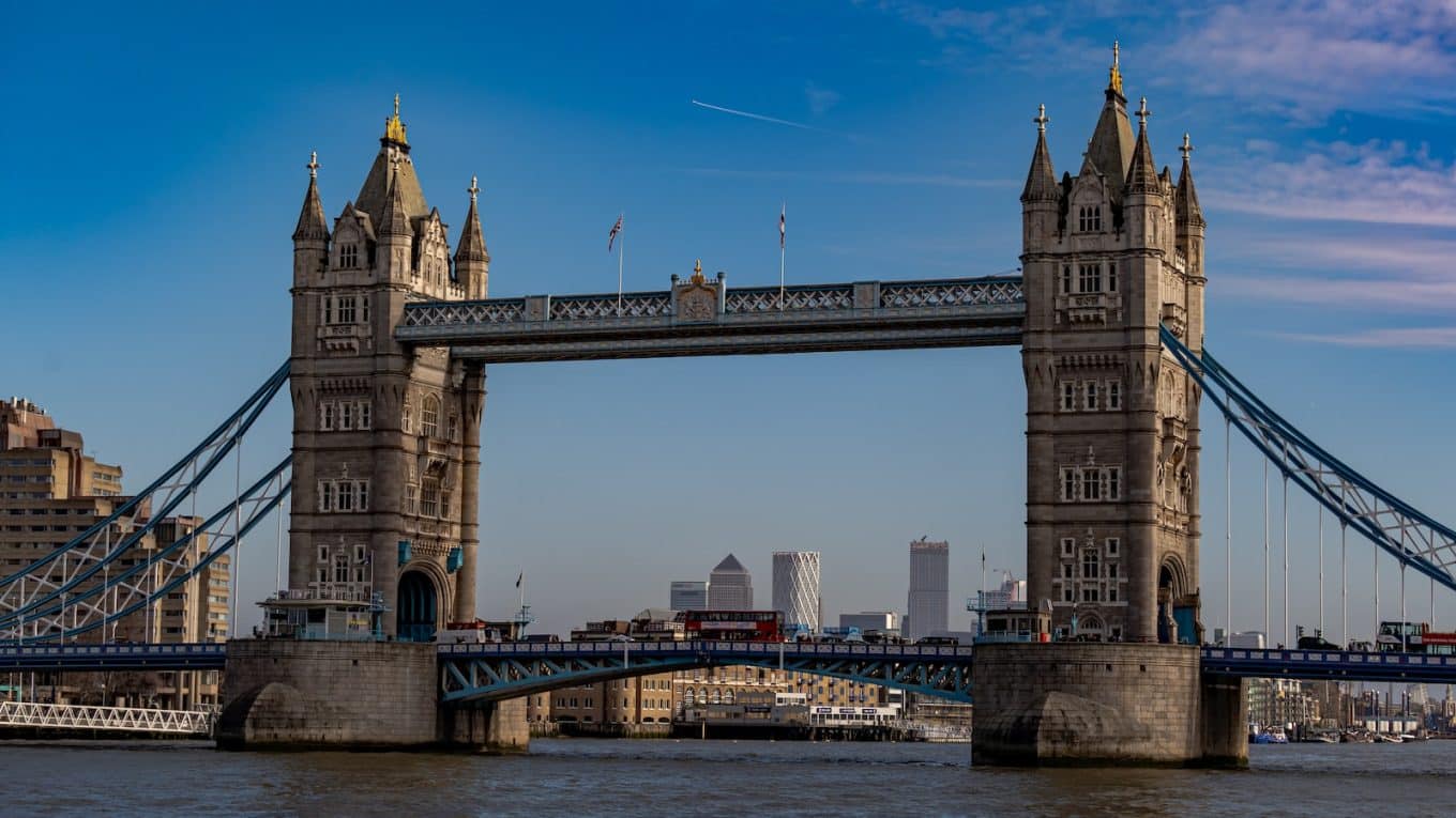 brown concrete bridge under blue sky during daytime